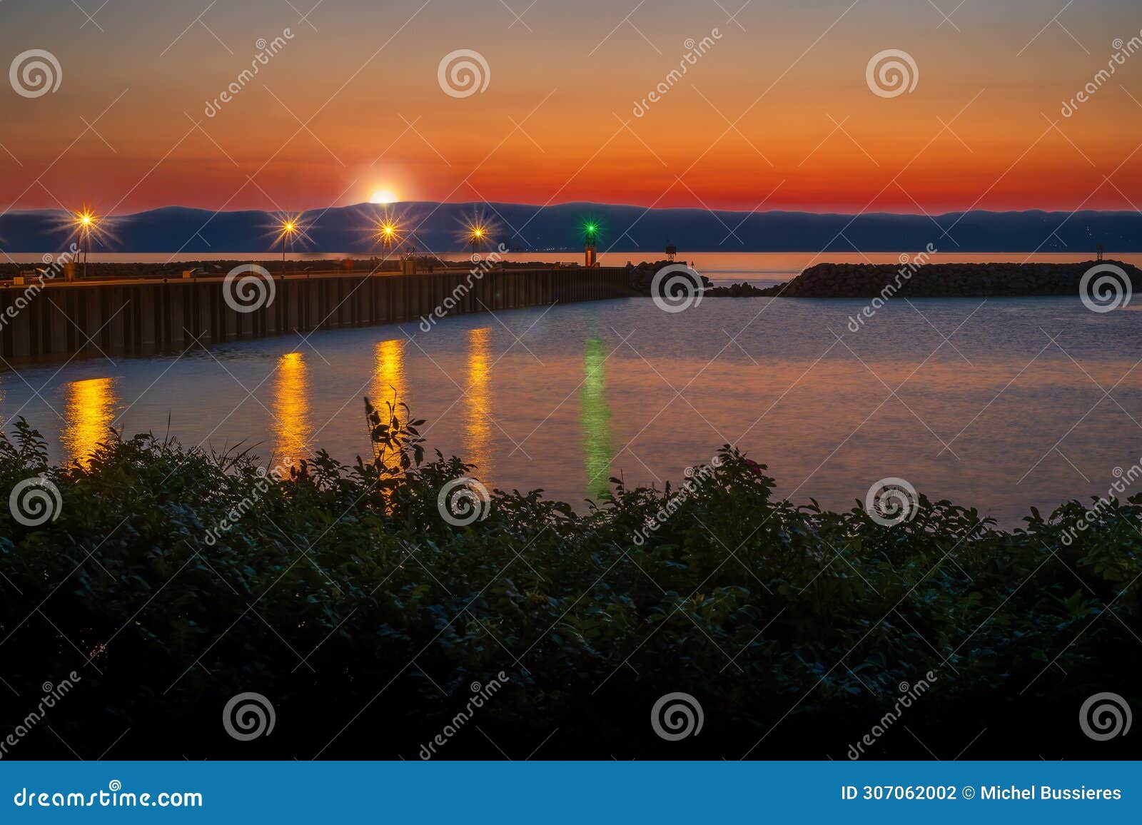 sunset at the saint jean port joli quay in the saint lawrence seaway