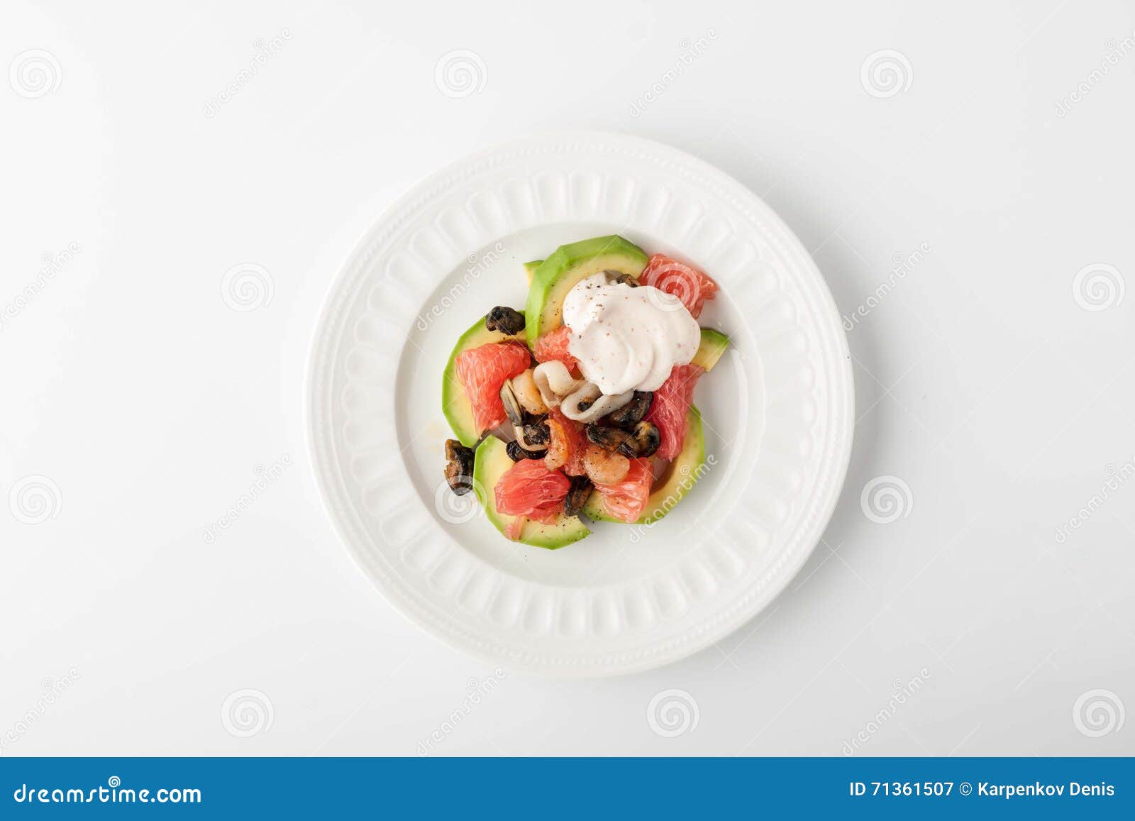 salad with avocado and seafood on a relief plate