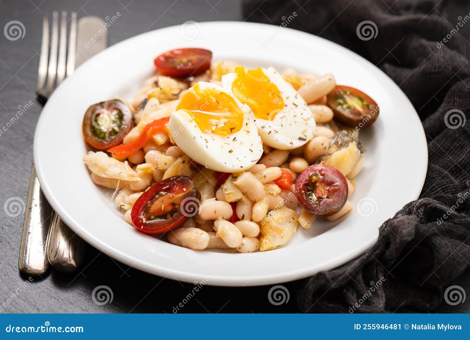 Salad with Fried Cod Fish and White Beans on the Plate. Stock Image