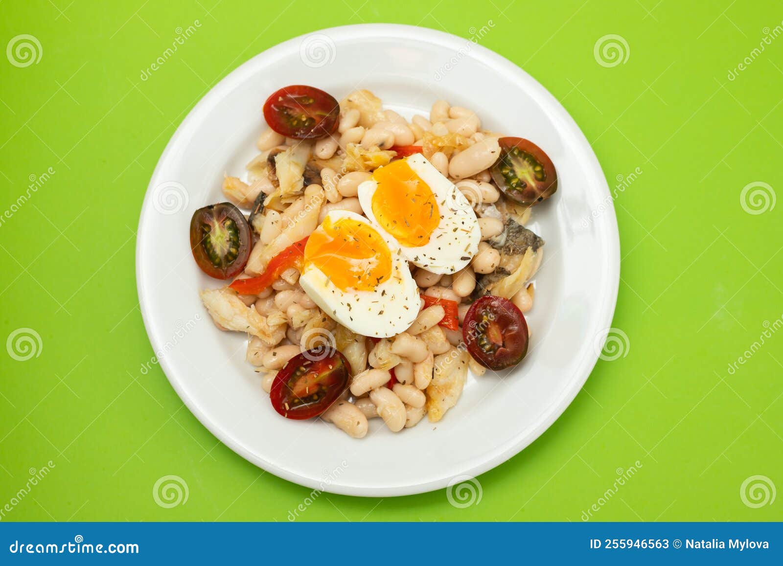 Salad with Fried Cod Fish and White Beans on the Plate. Stock Image