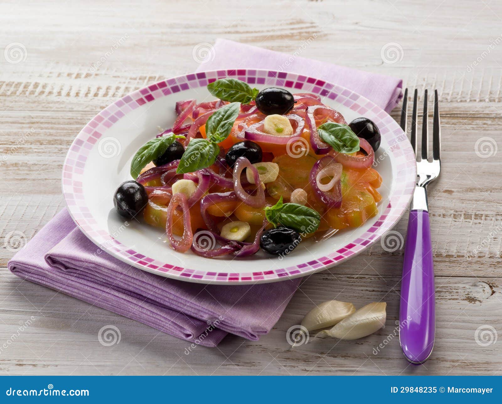 Salad with ox heart tomatoes, onions olives and garlic