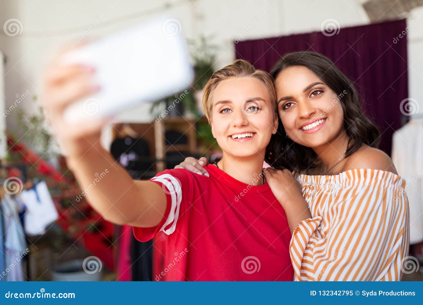 Female Friends Taking Selfie at Clothing Store Stock Image - Image of ...