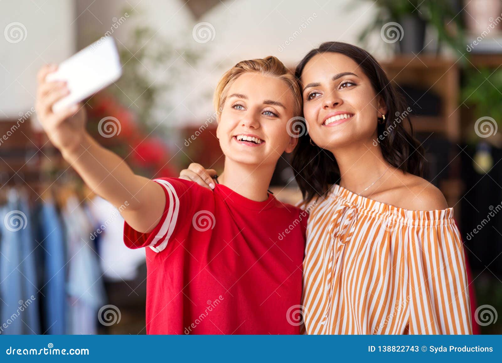 Female Friends Taking Selfie at Clothing Store Stock Image - Image of ...