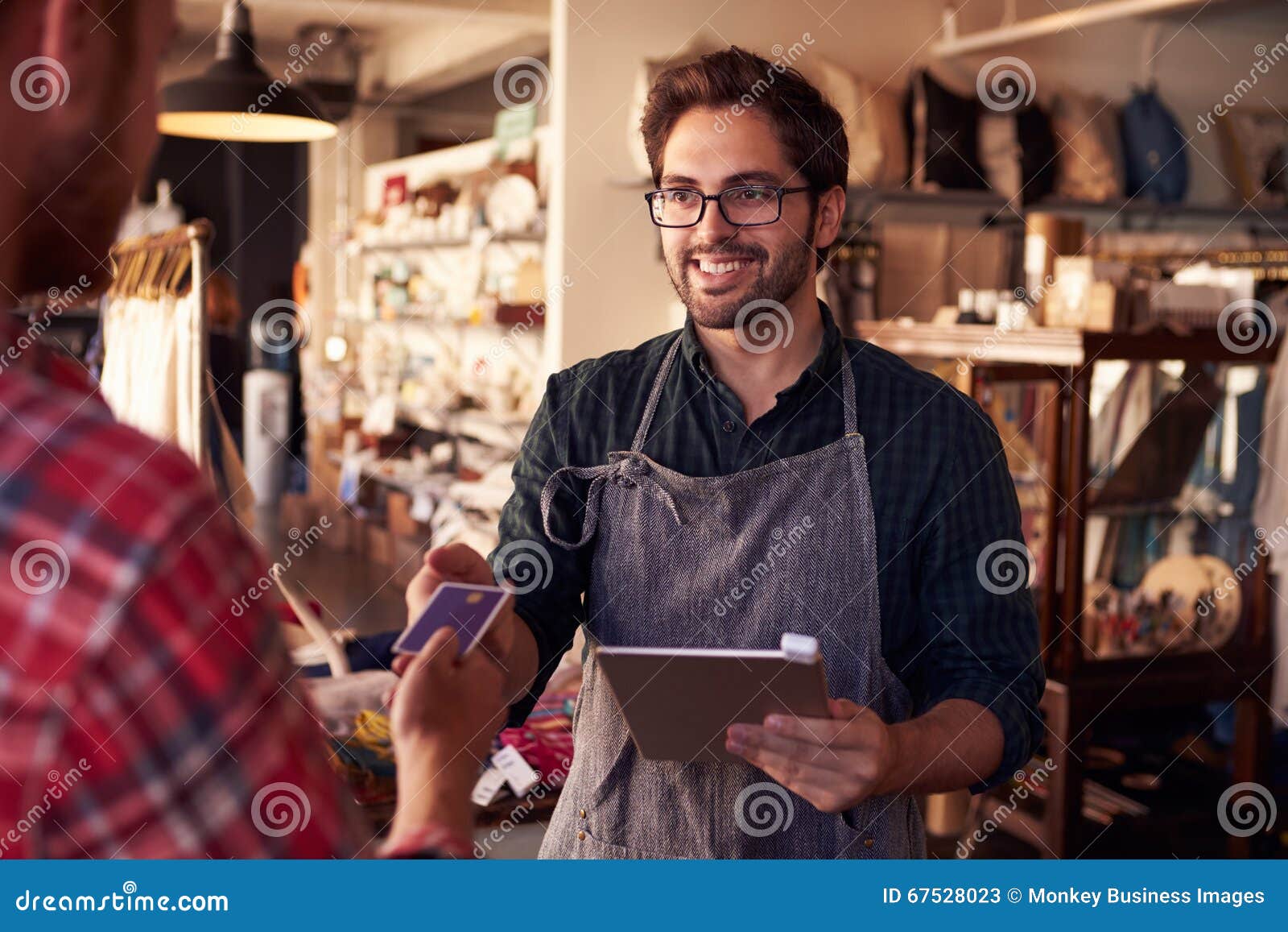 sales assistant with credit card reader on digital tablet