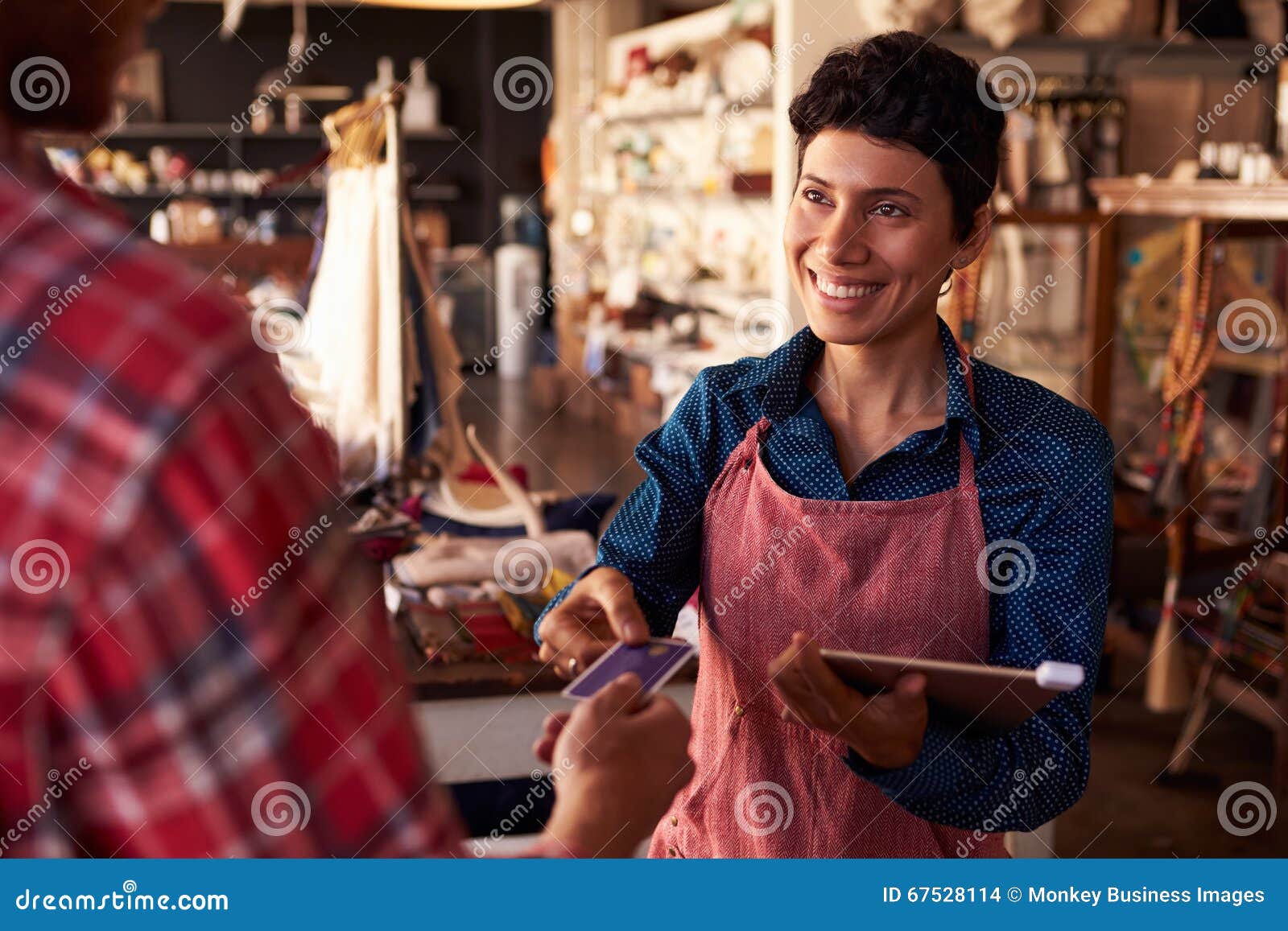 sales assistant with credit card reader on digital tablet