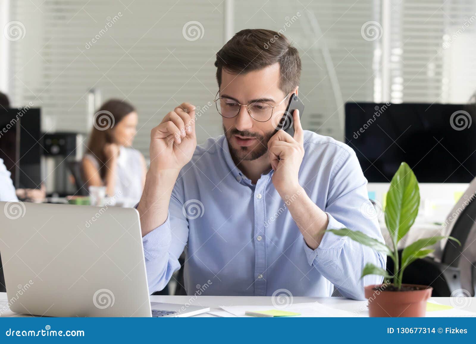 sales manager consulting client talking on phone in office