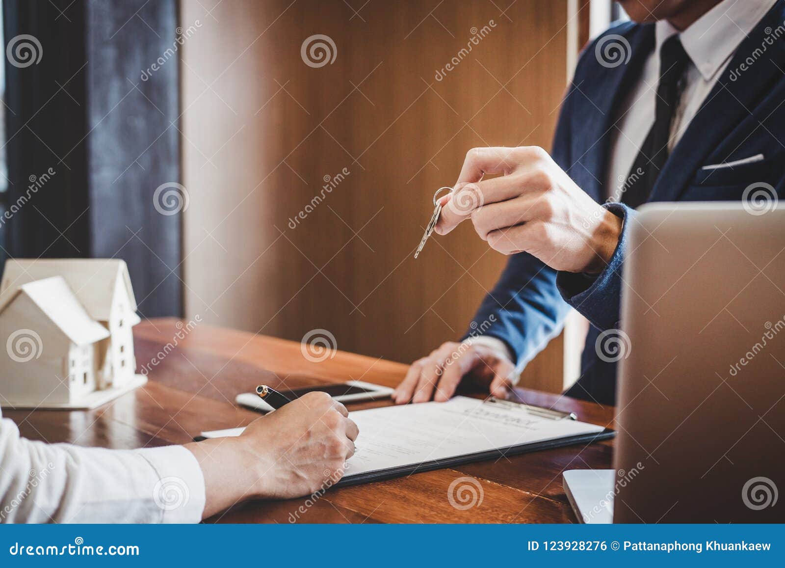 Sales Manager Filing Keys To Customer After Signing Rental