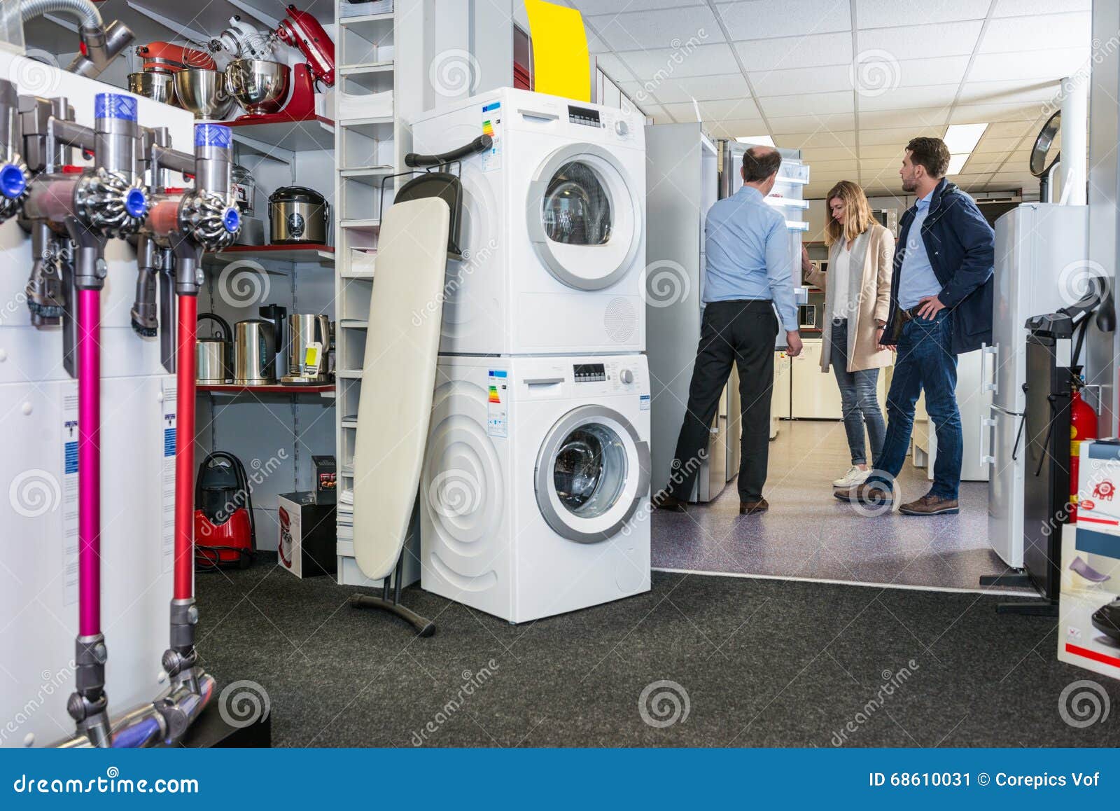 Salesman Assisting Couple in Buying Refrigerator Stock Image - Image of ...