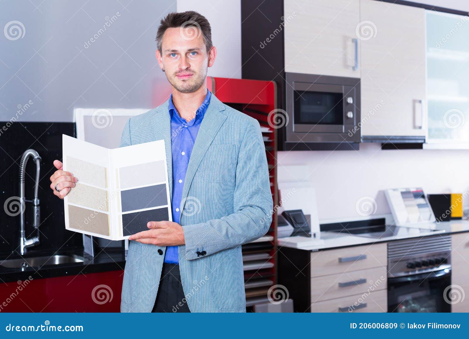 Salesman of Furniture Accessories Store Showing Variants of Stone Stock
