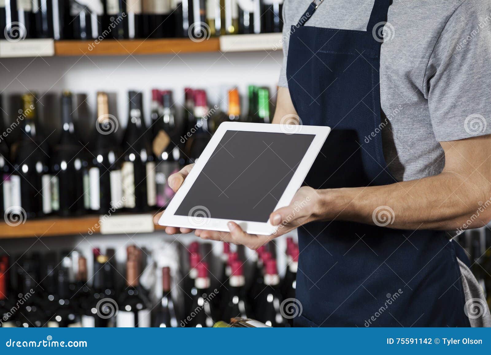 Salesman Showing Blank Digital Tablet in Wine Shop Stock Photo - Image