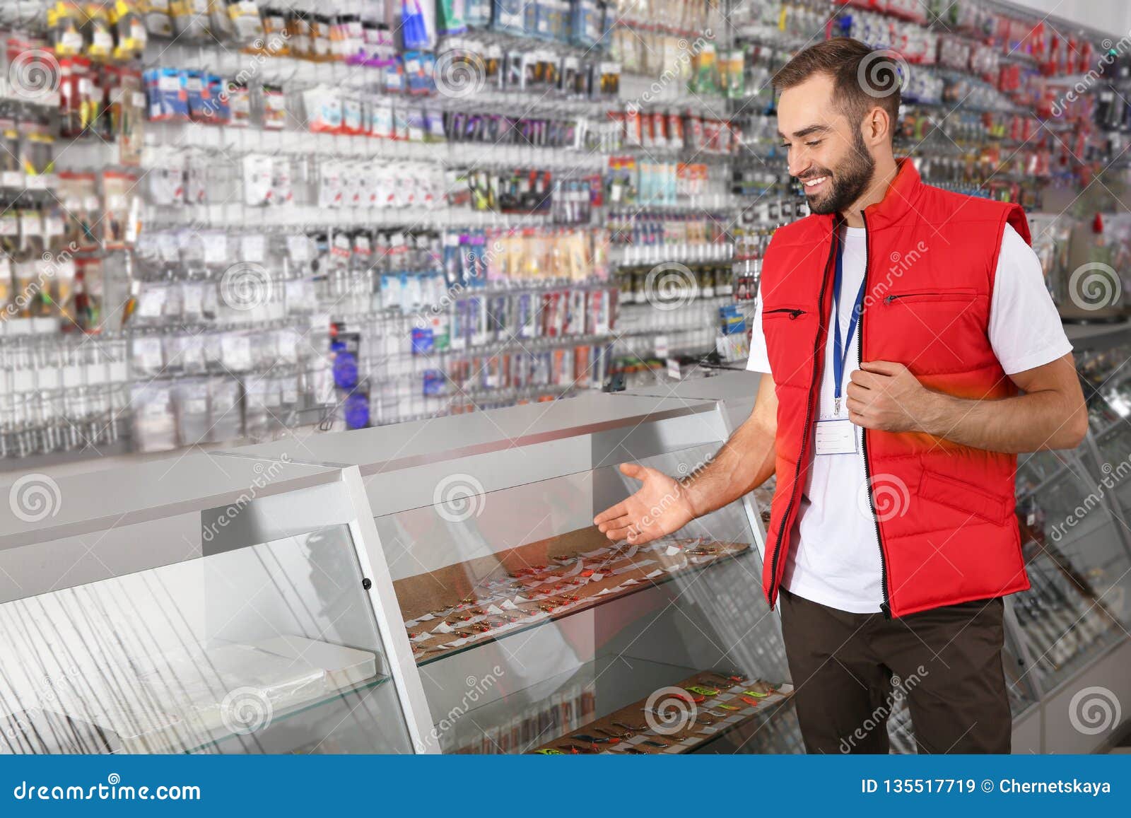 Salesman Standing Near Showcase With Fishing Equipment In Sports Shop. Stock Image - Image of ...