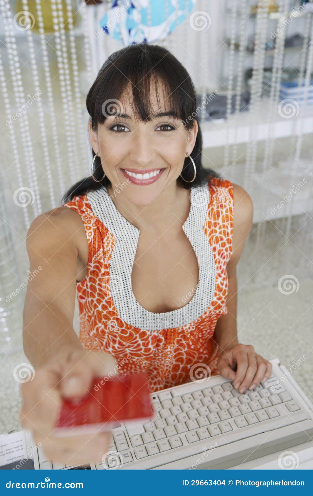 saleswoman handing credit card back to customer