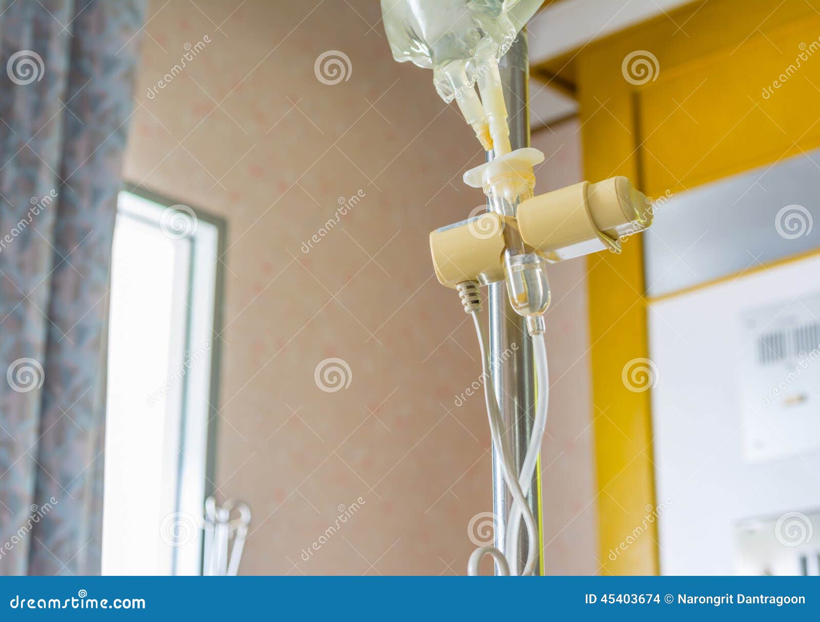 Saline Bottle In The Hospital. IV Tubing. The Vet Is Giving The Dog A