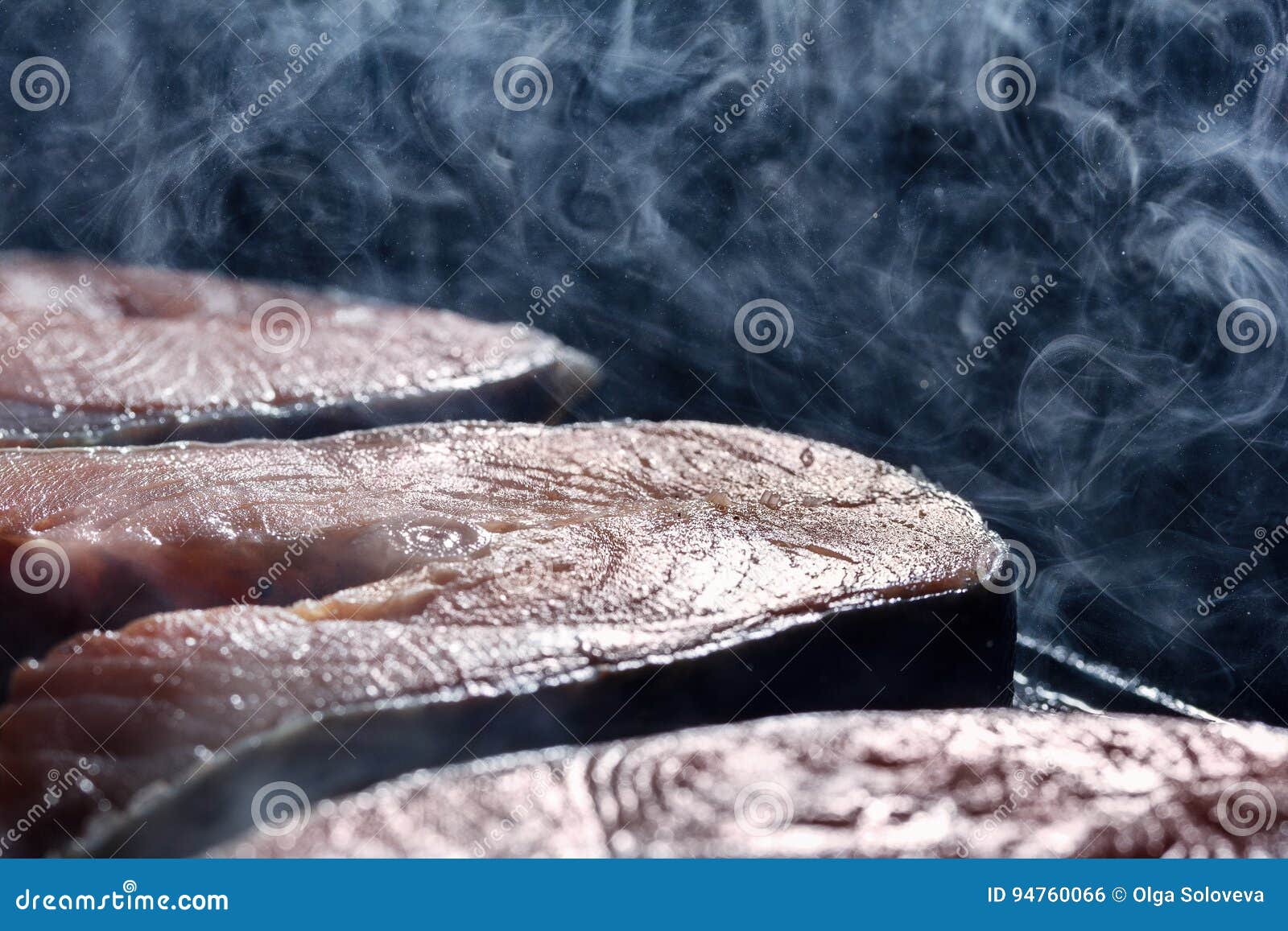 Salmon Steak in a Smoke and a Couple of Fried in a Pan Grill Stock
