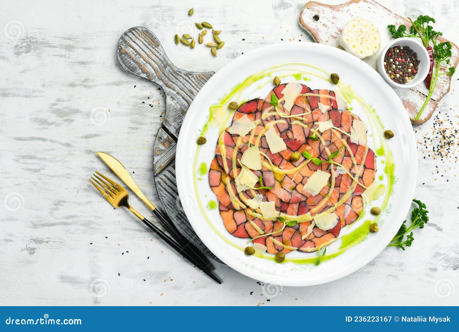 Salmon and Tuna Carpaccio with Sauce and Cheese on a White Plate. Stock