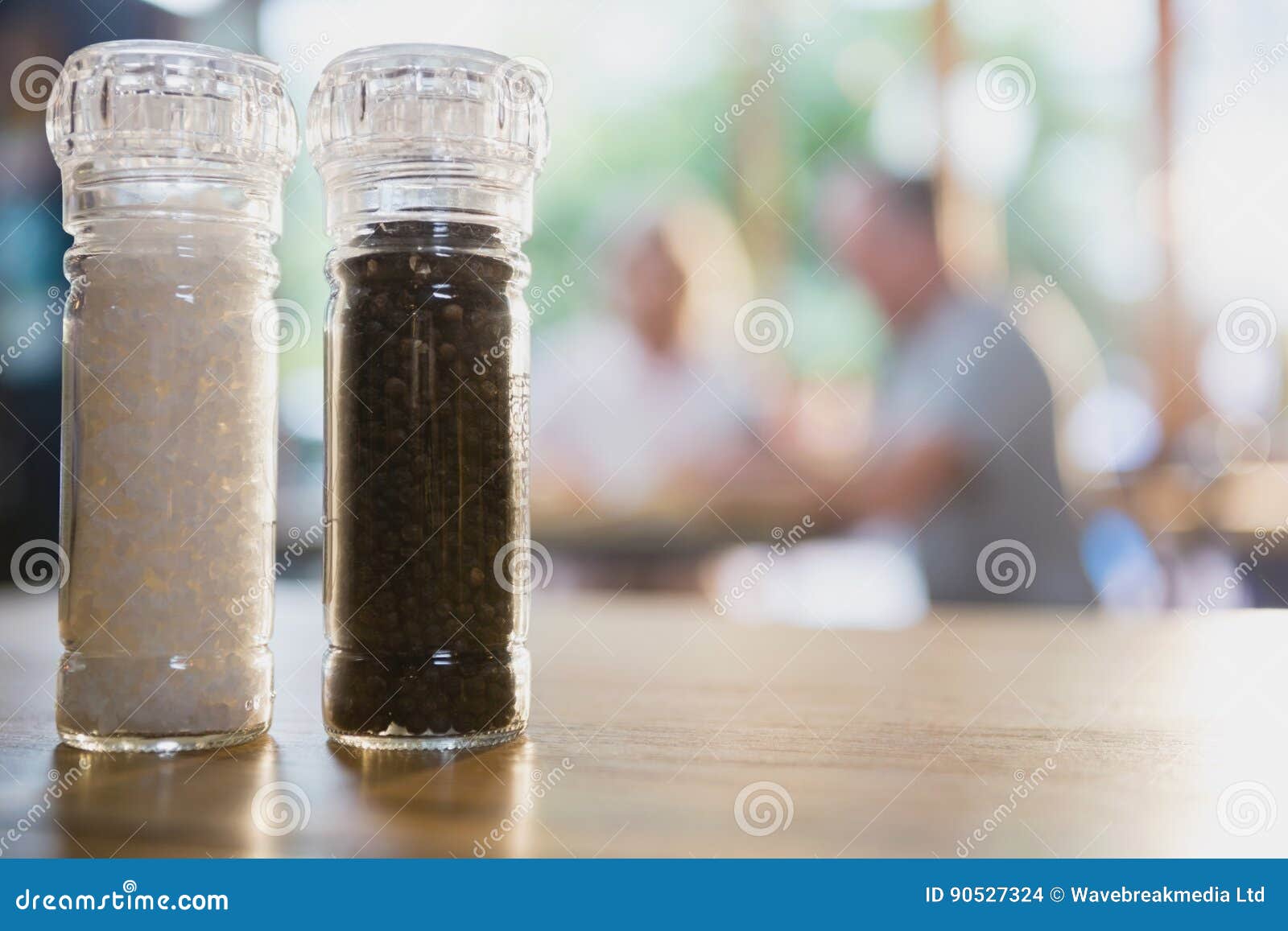 Salt and Black Pepper Shakers on a Table Stock Photo Image of