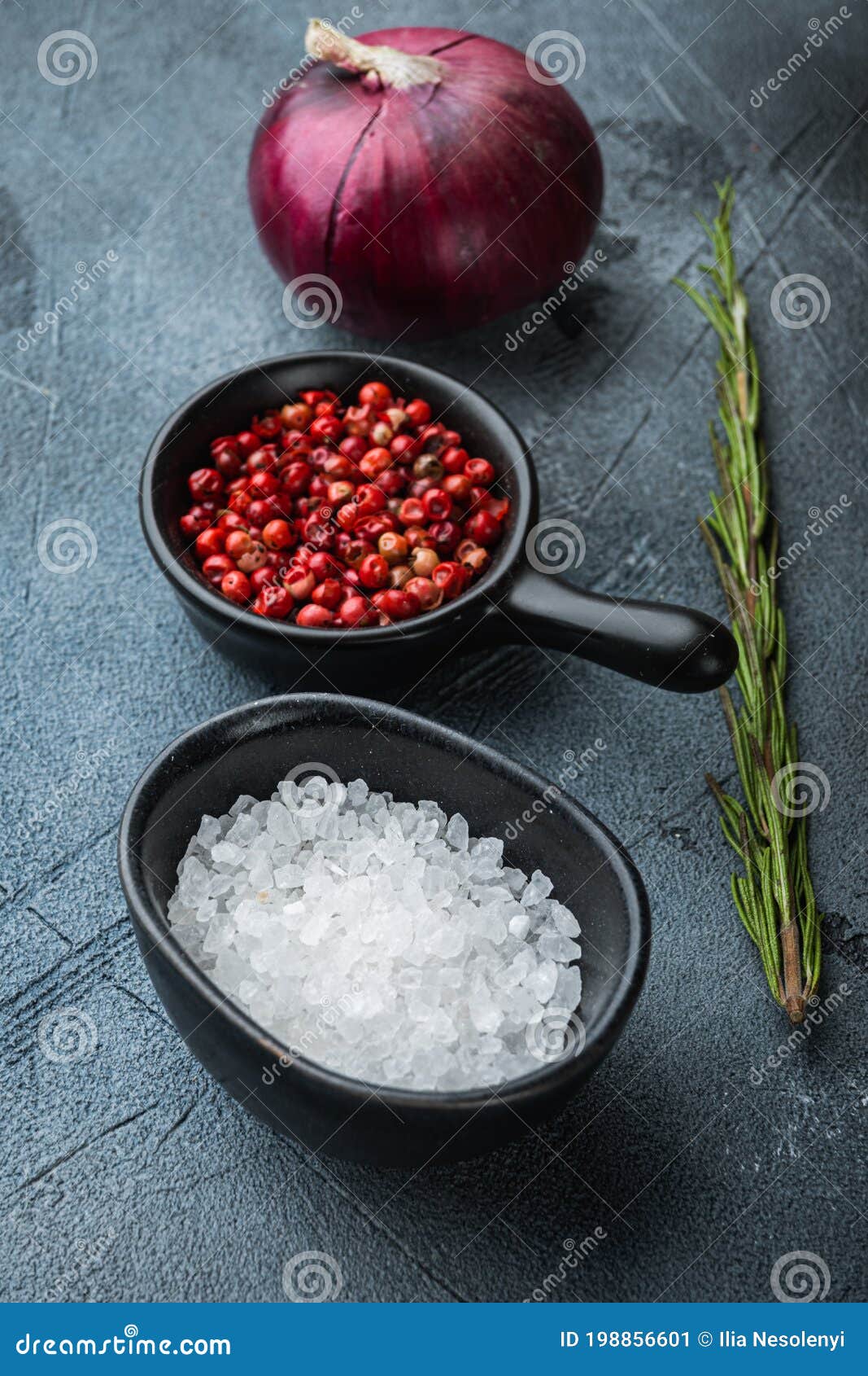 Salt and Pepper in Bowls on Grey Textured Background Stock Image