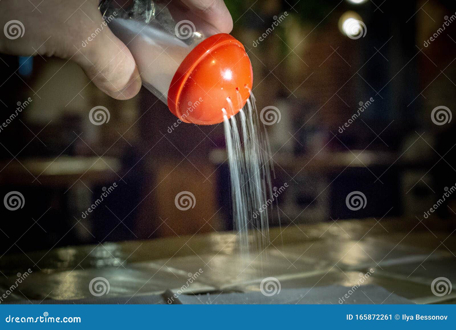 Salt is Poured Down from the Salt Shaker. in the Cafe Stock Image