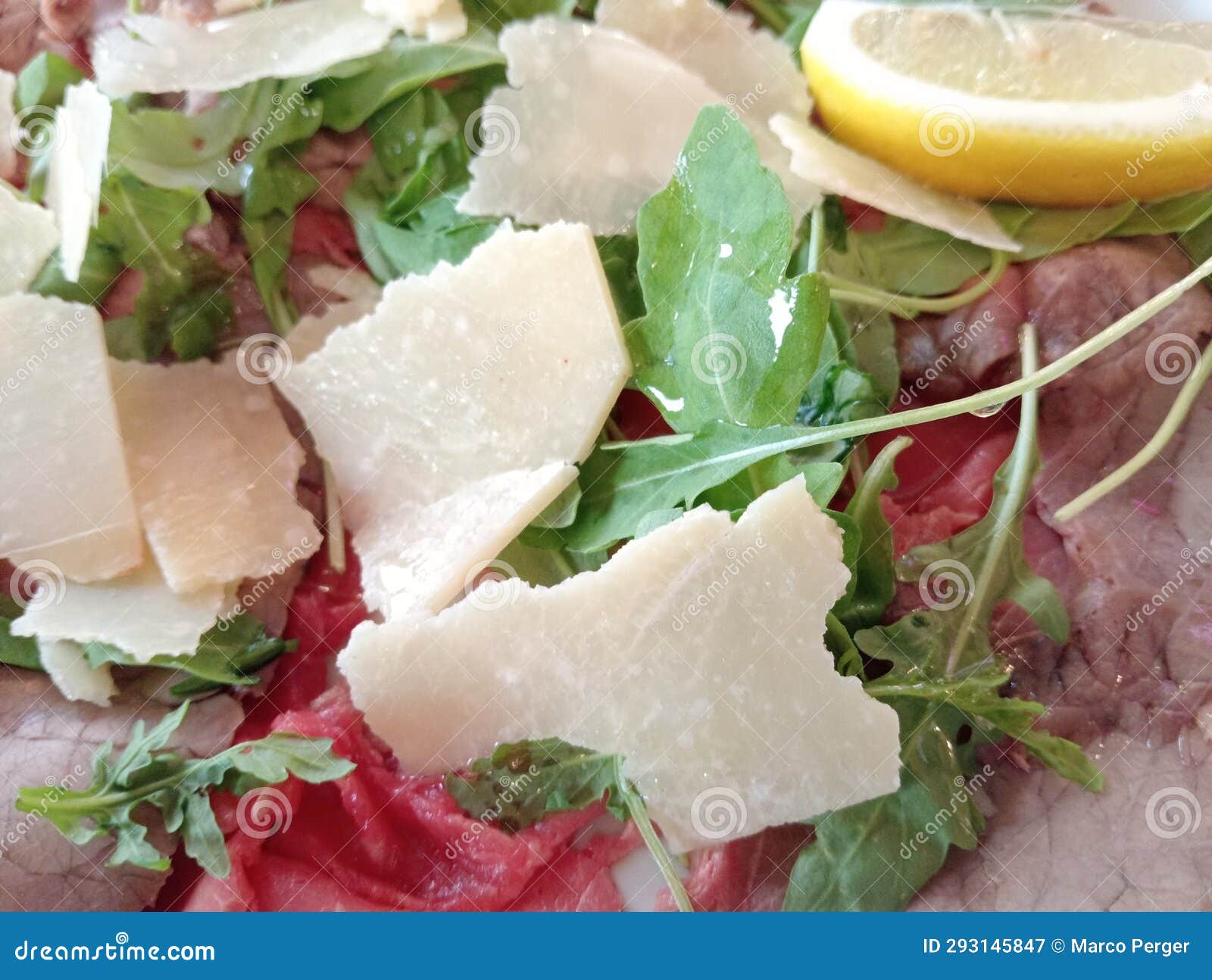 Salt Roast Beef Dish with Parmesan Flakes, Rocket and Slice of Lemon