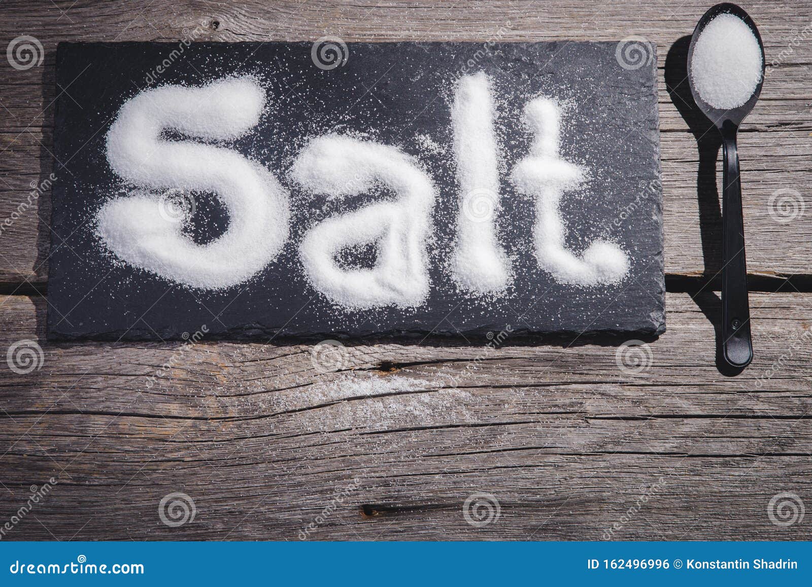 Salt Written on Counter in Spilled Salts from Shaker Stock Photo