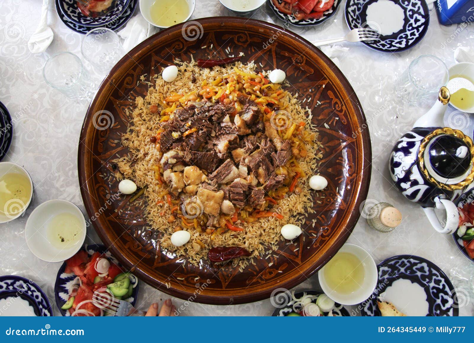 Samarkand Pilaf with Quail Eggs on a Ceramic Dish in a Restaurant Stock