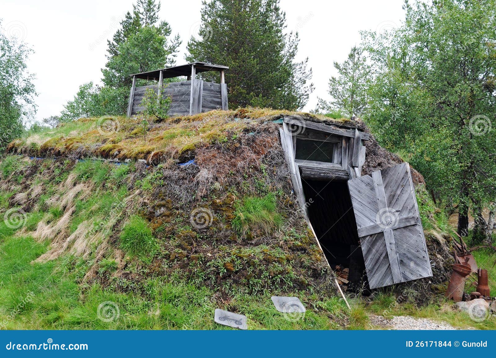 house near a lake in finland , built like a traditional sami house 