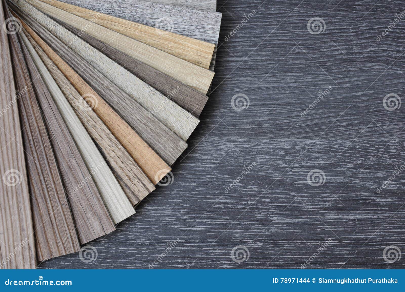 samples of laminate and vinyl floor tile on black wooden background