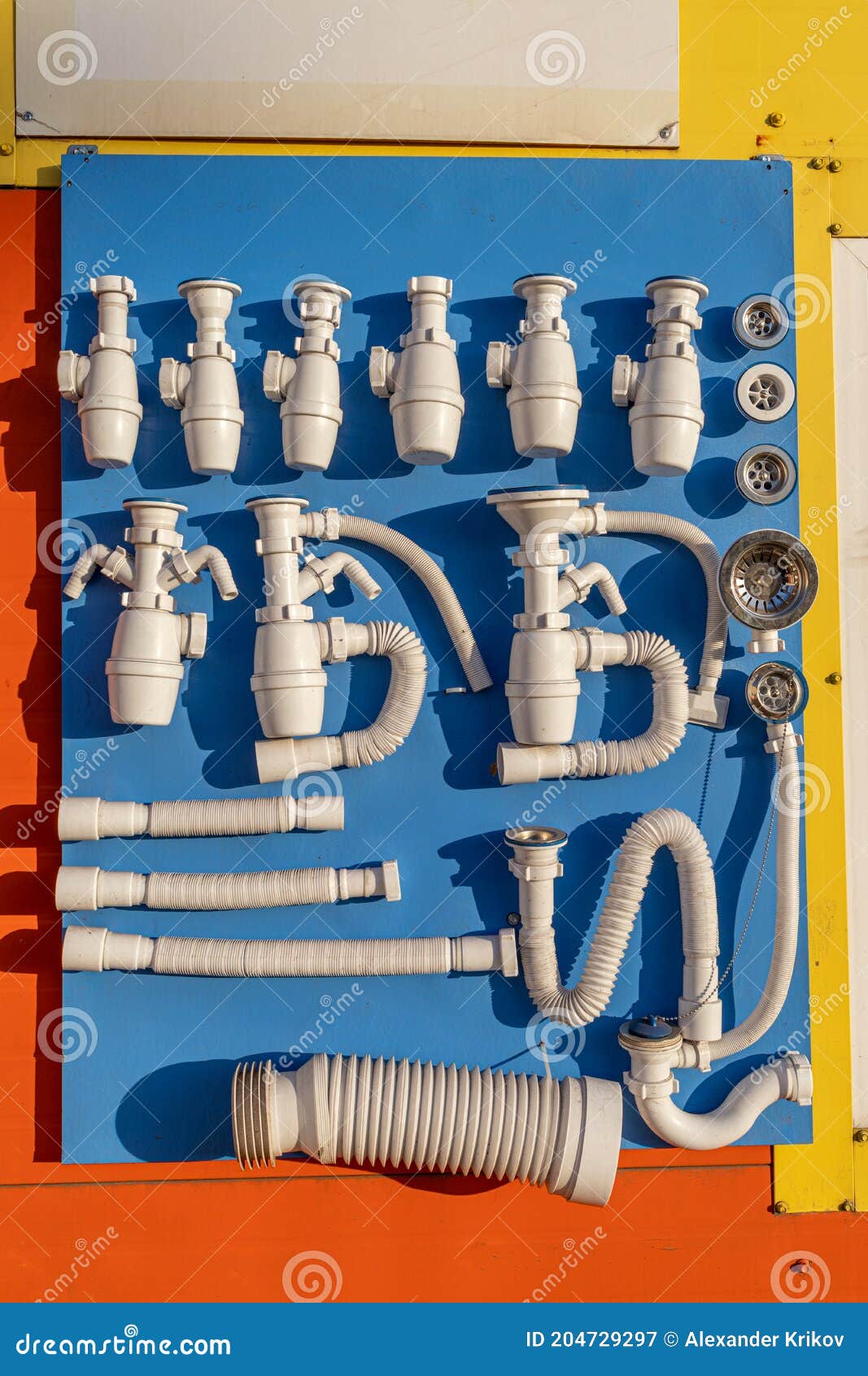 Samples Of Sanitary Fittings Fixed On A Wall Stand In The Building