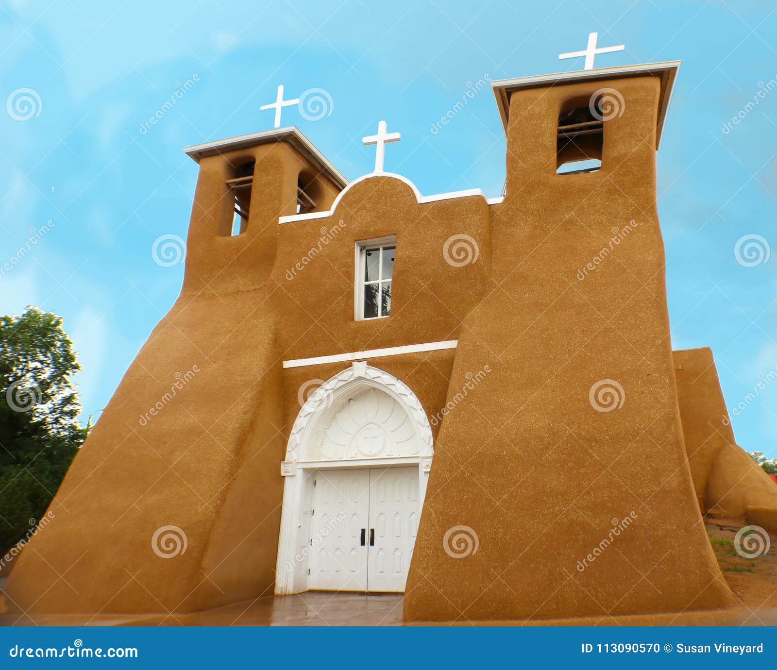 san francisco de asis mission church in rain - unique adobe architecture located in taos new mexico