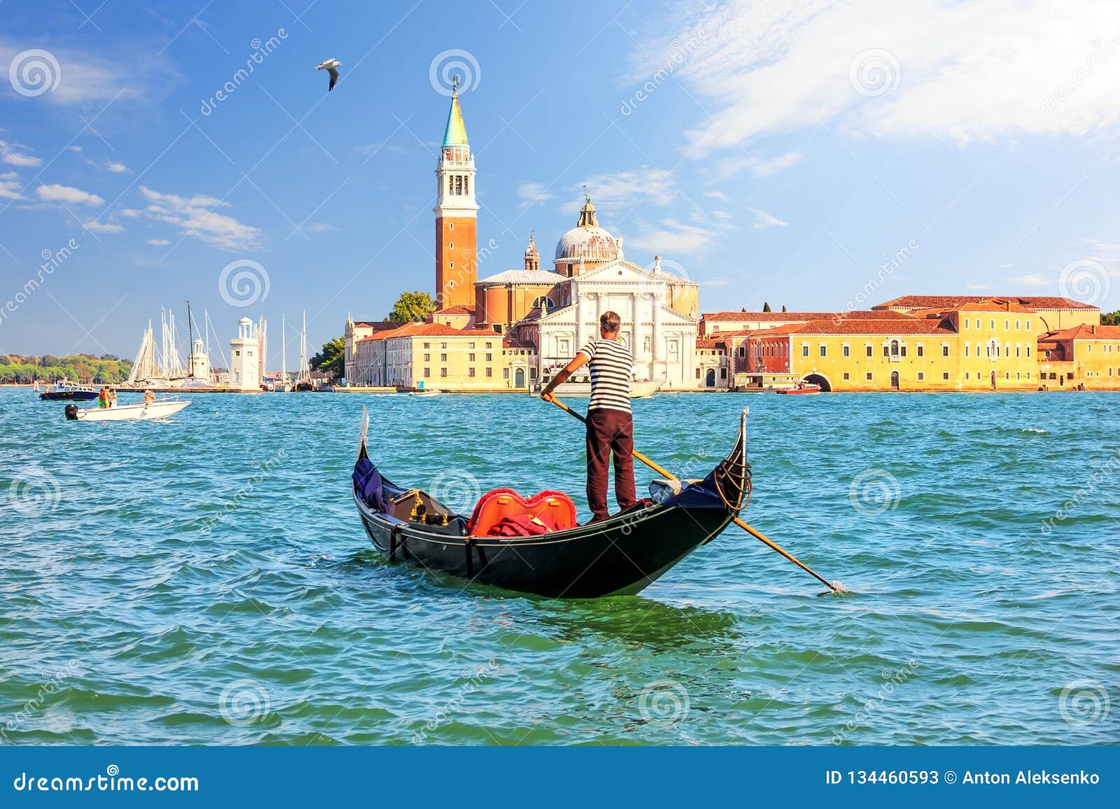 san giorgio maggiore island of venice and a traditional gondolier in his gondola