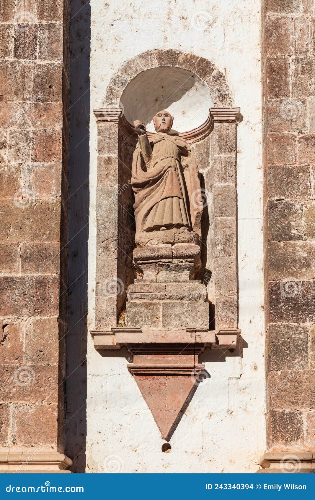 sculpture of a priest on the san ignacio mission in baja.