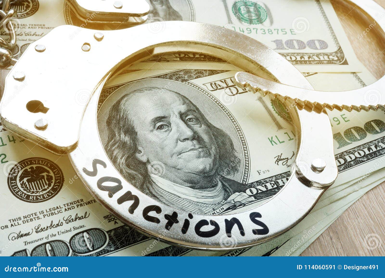 sanctions on a handcuffs and american dollar bills. economical restrictive measures.