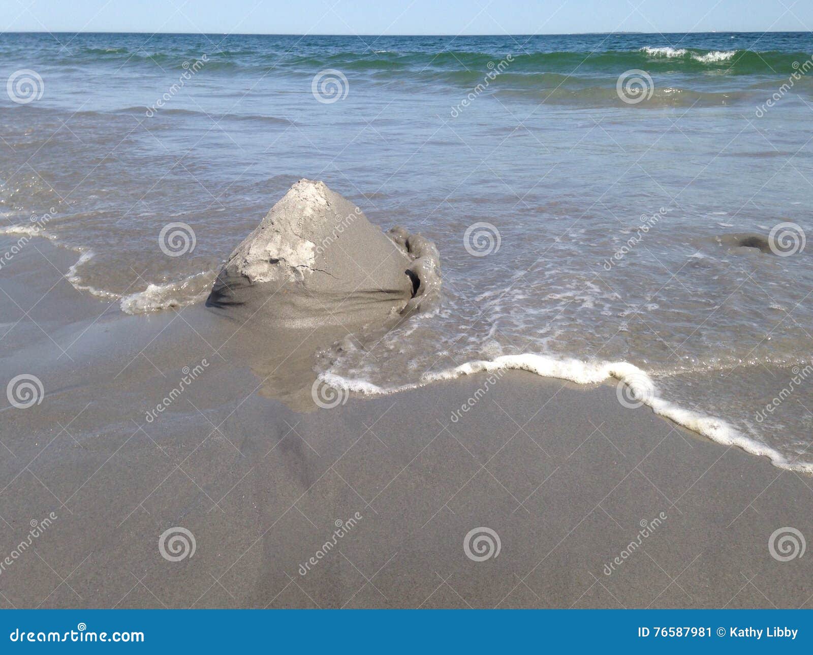 Sand castle washing away stock image. Image of blue, 76587981