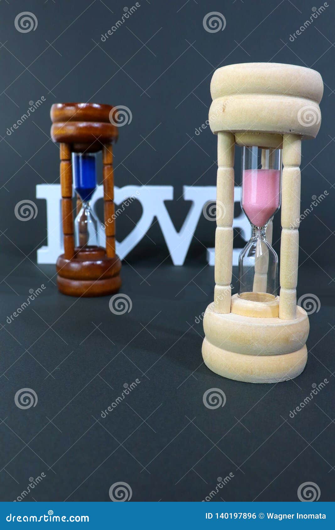 sand clock representing woman in front of man
