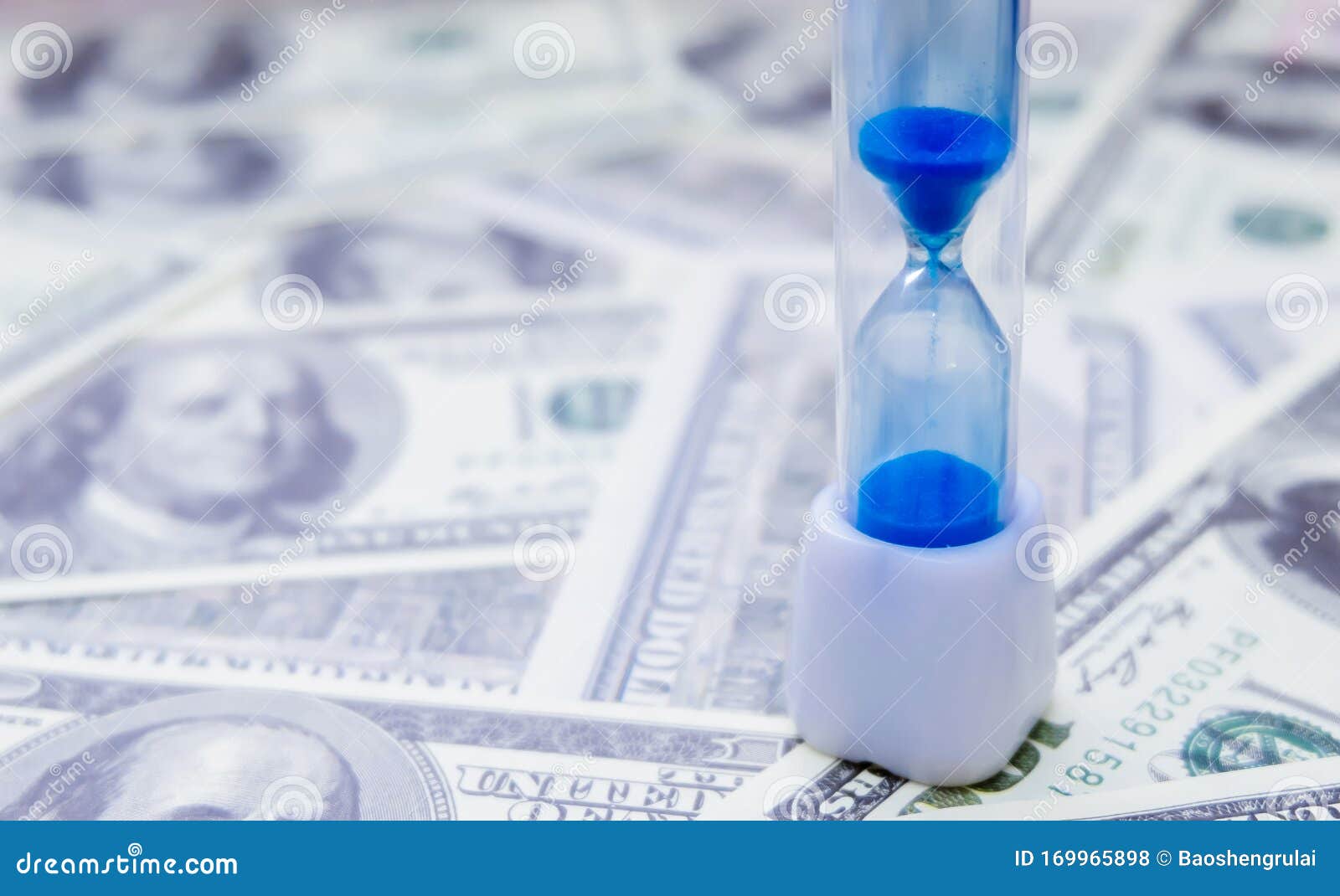 sand clock and dollar bill background