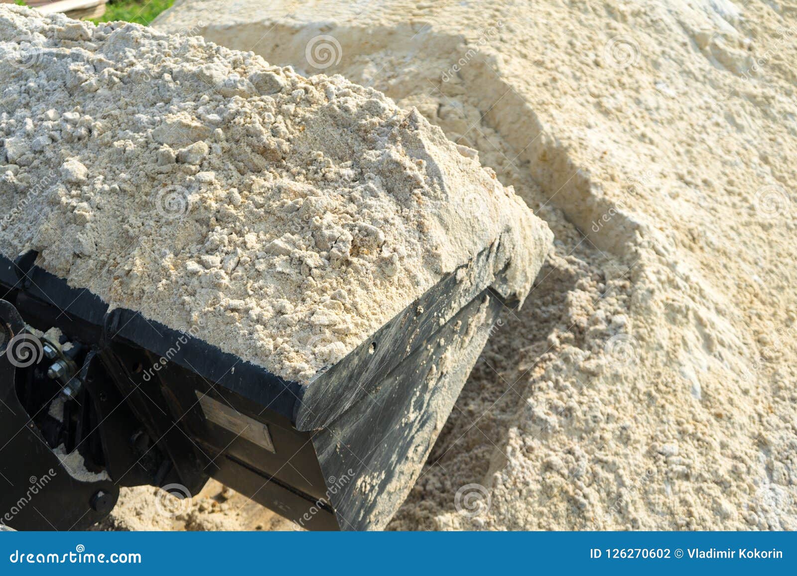 Sand for Construction Works is Collected in a Loader Bucket. Stock