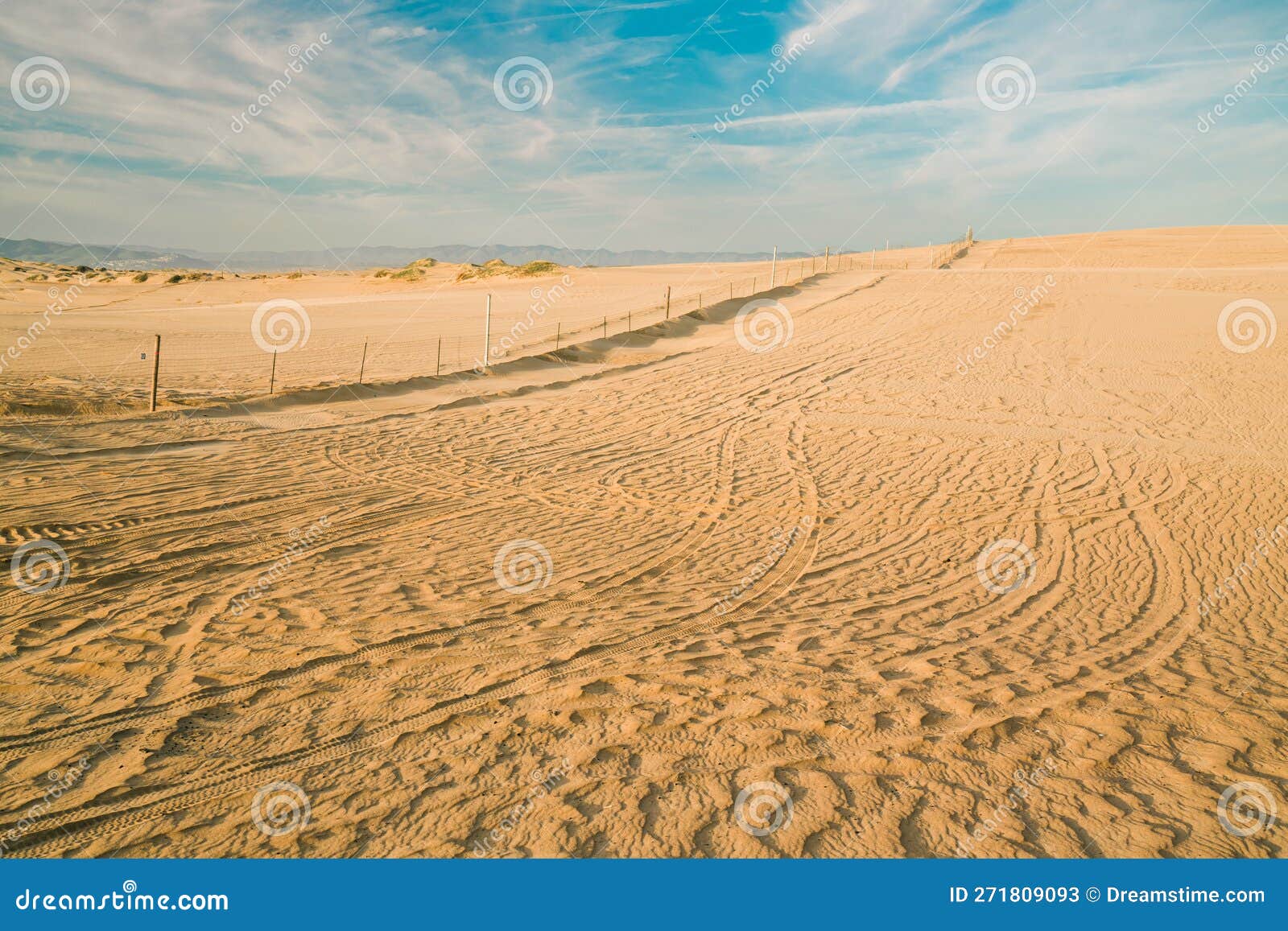 sand dunes and tire tracks on sand, oceano, california