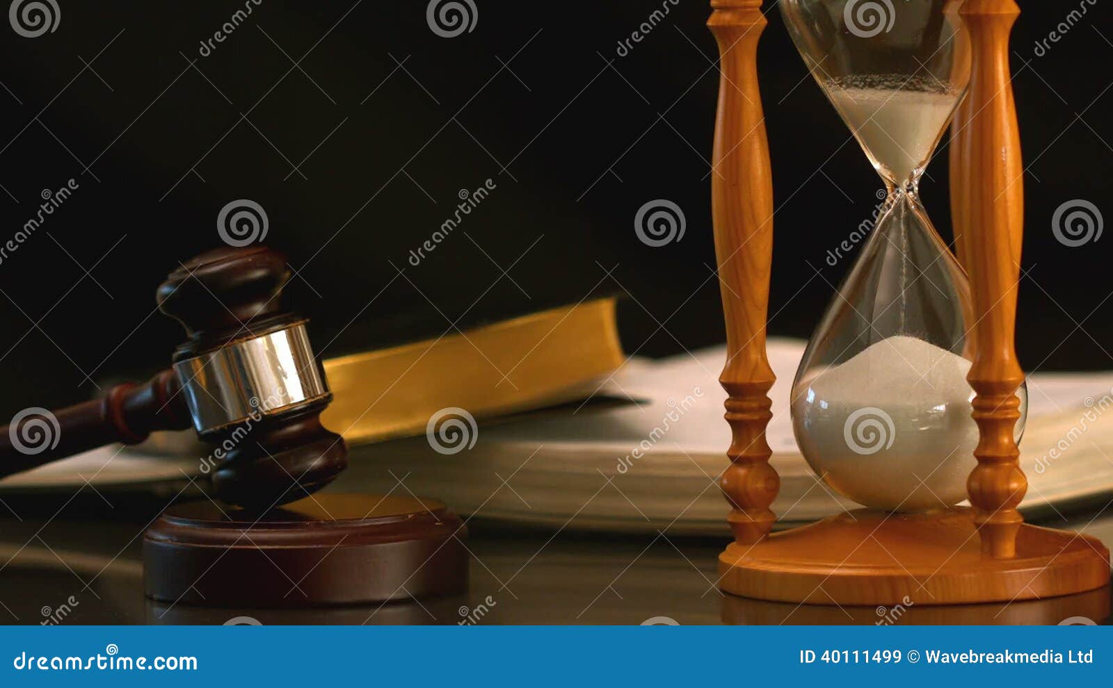 Sand Flowing through Hourglass beside Gavel and Bible Stock Video