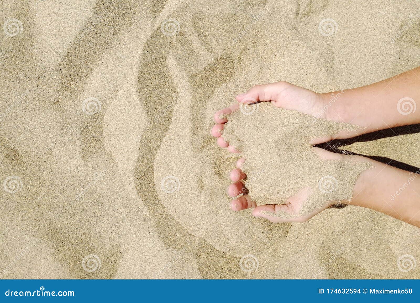 sand in hands of girl. hand strew sand