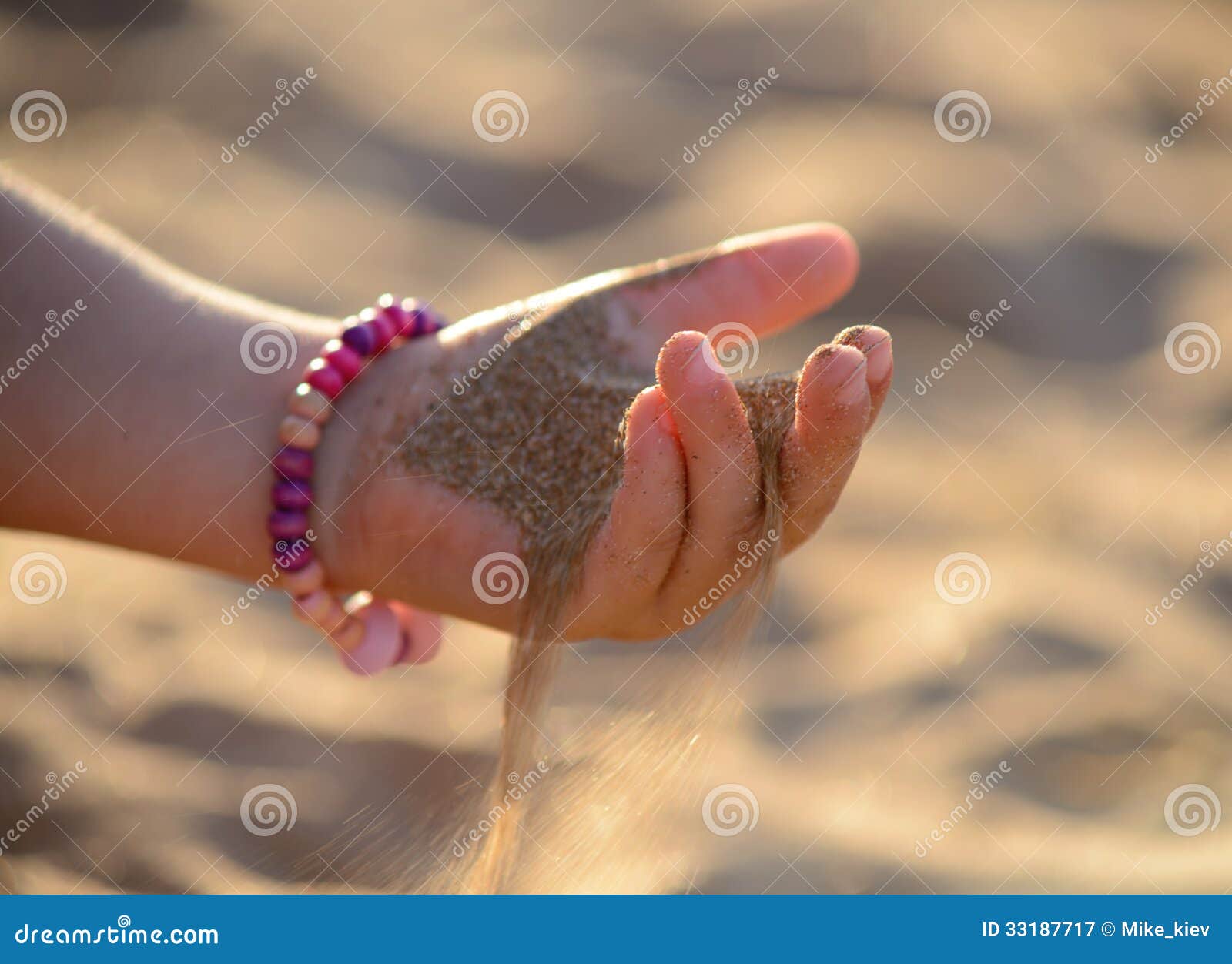 sand pours out of the child hand