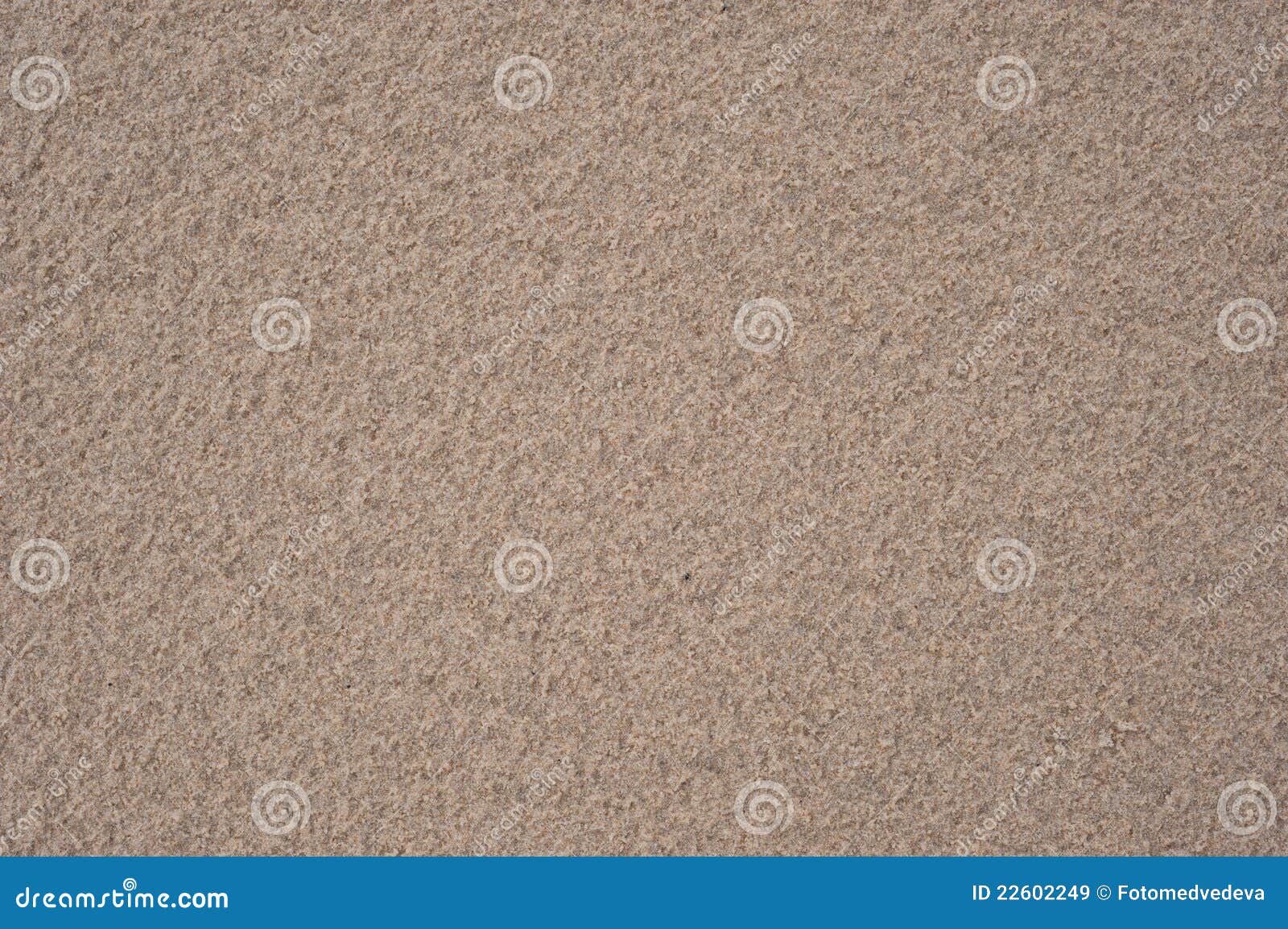 Sand after rain. Beige background of wet sand with a relief