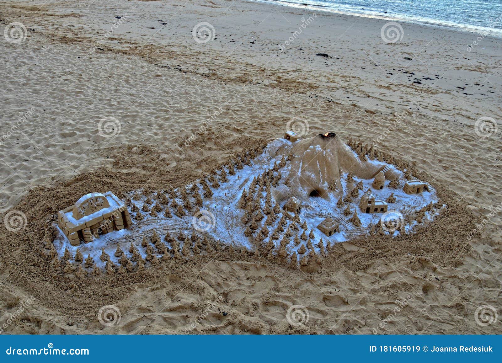 Sand Sculpture on the Beach Against the Backdrop of the Ocean Stock