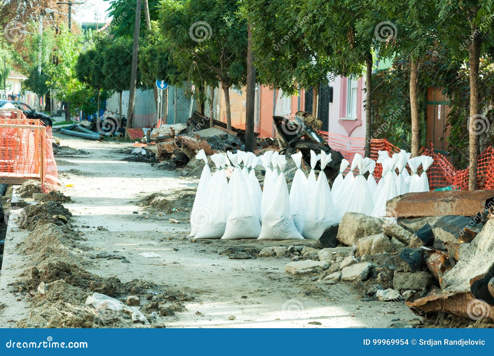 sand in white plastic nylon bags on the street reconstruction site.