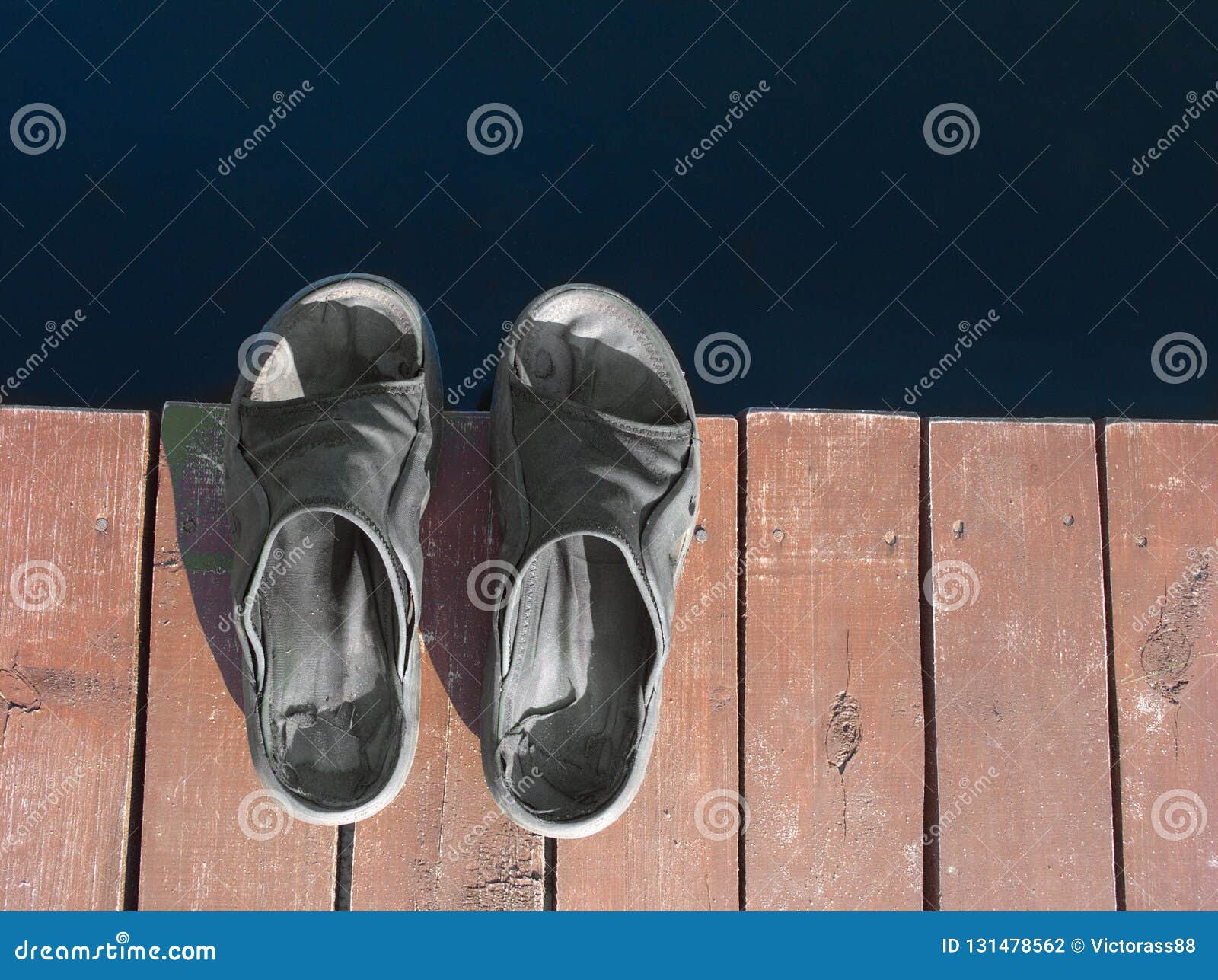 Sandals on a wooden bridge stock photo. Image of bridge - 131478562