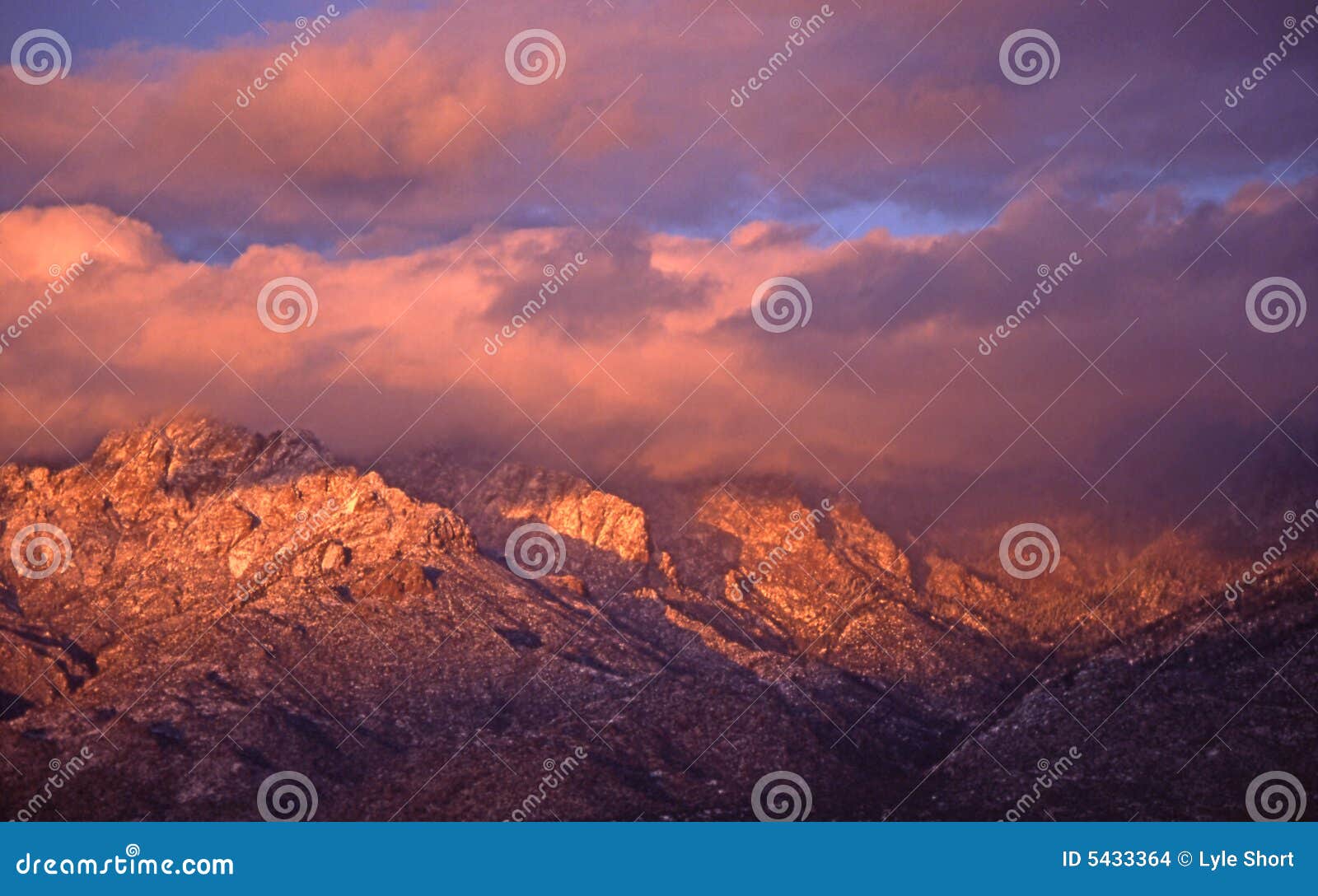 sandia peak in clouds at sunset