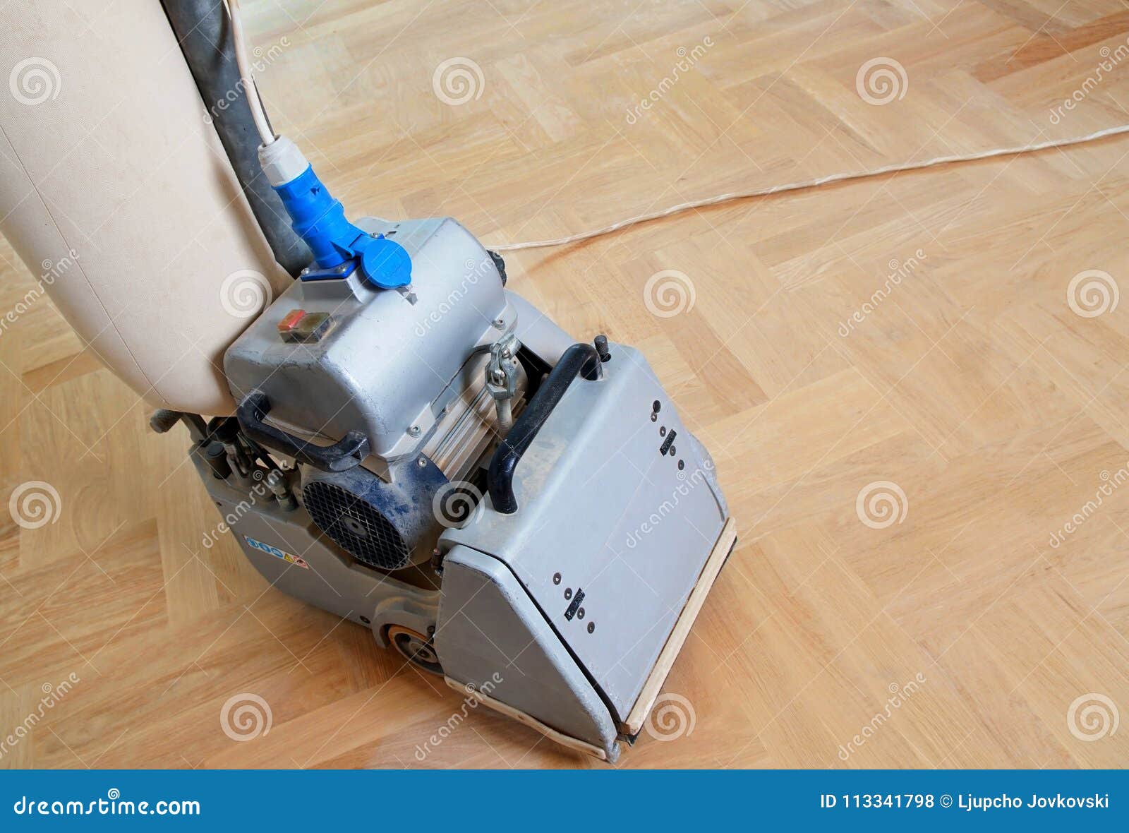 Sanding Hardwood Floor With The Grinding Machine Stock Photo