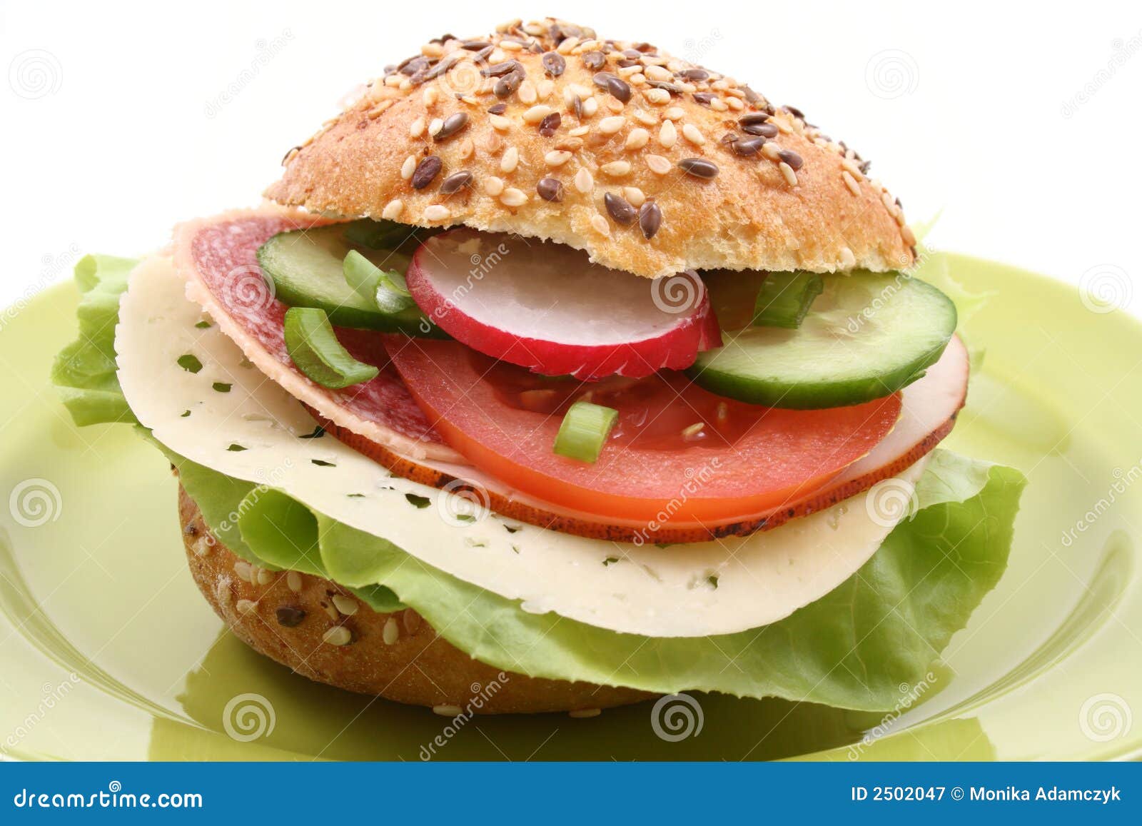 Delicious sandwich with cheese salami and vegetables isolated on white