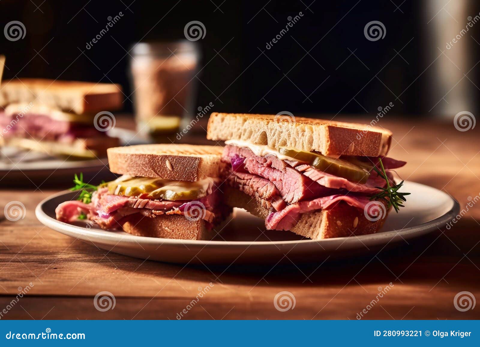Sandwich With Pastrami Pickles And Red Onions On Toasted Sourdough Bread On White Plate