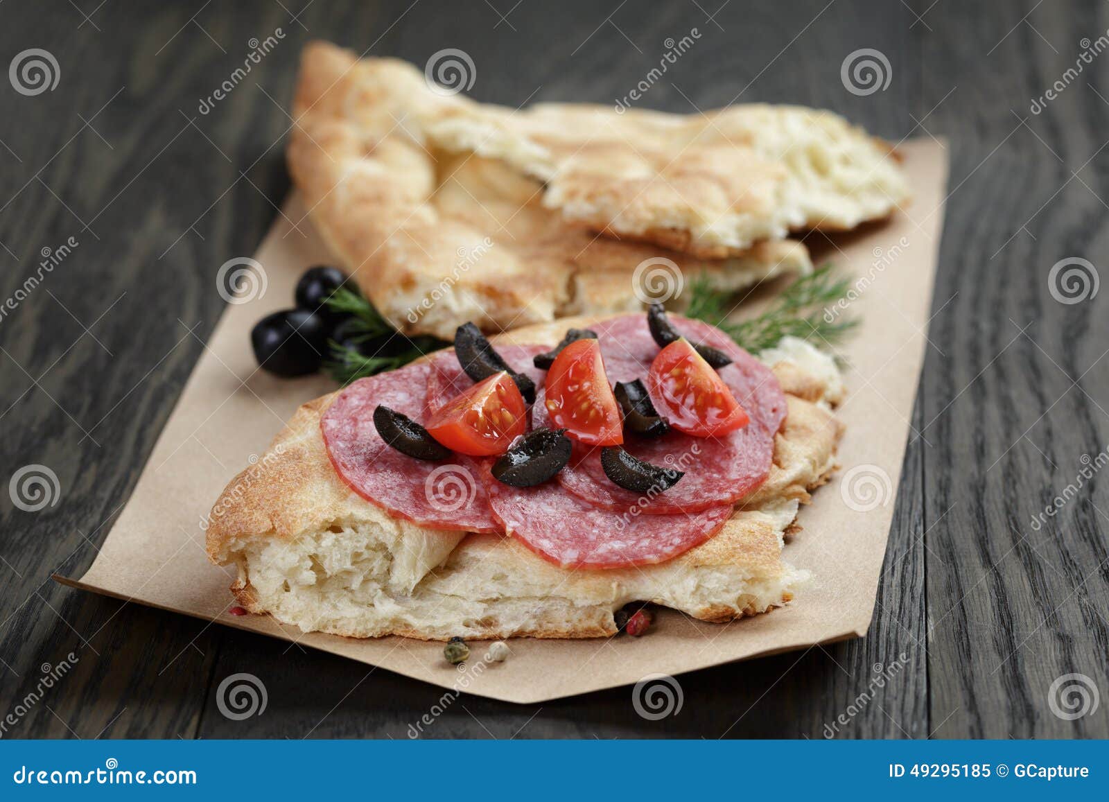 Sandwich with Pita Bread Salami and Vegetables on Wood Table Stock