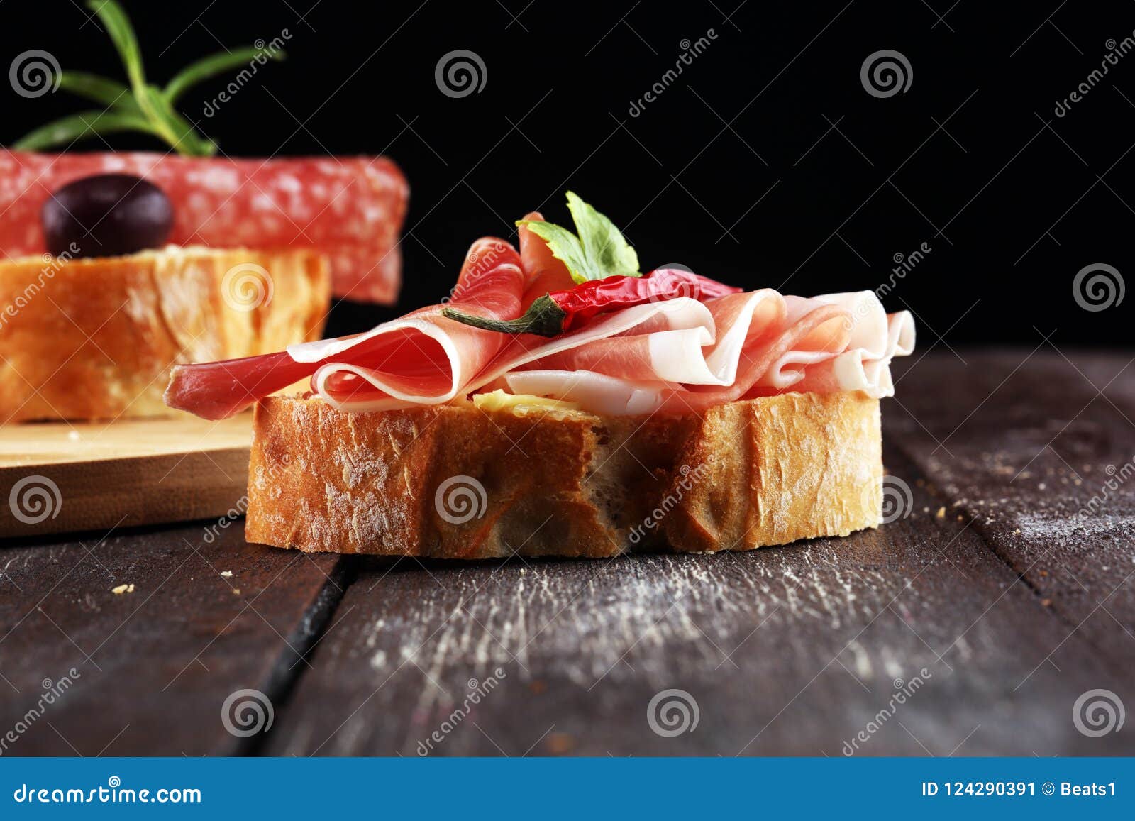 Sandwich with Prosciutto or Salami or Crudo. Antipasti Gourmet B Stock